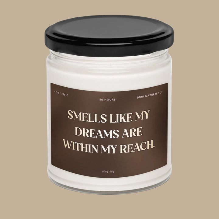 Candle jar with a brown label and black lid on a white background