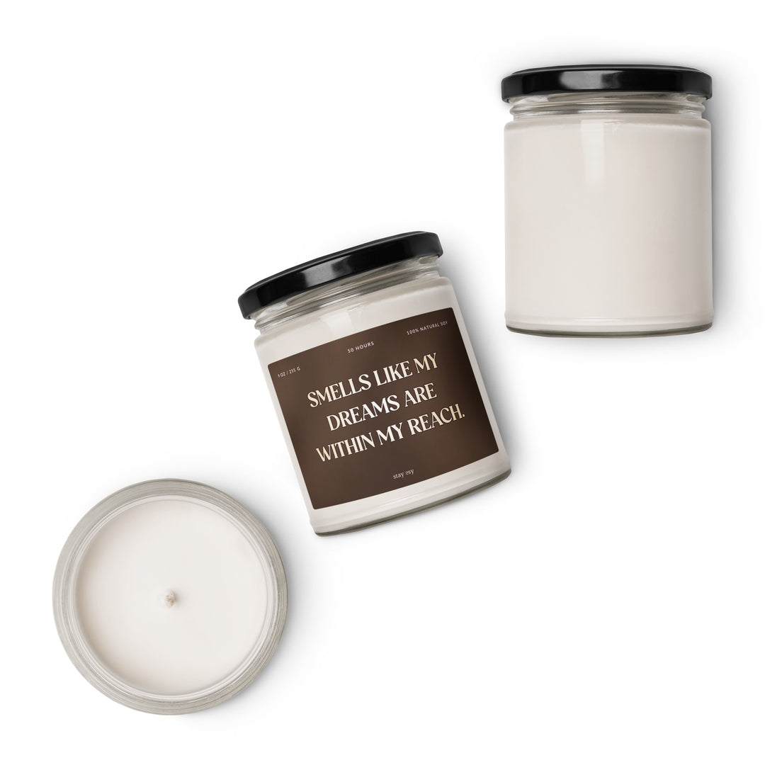 Two candles with text on the label against a white background