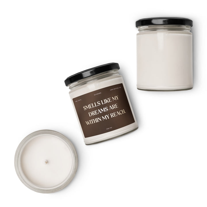 Two candles with text on the label against a white background