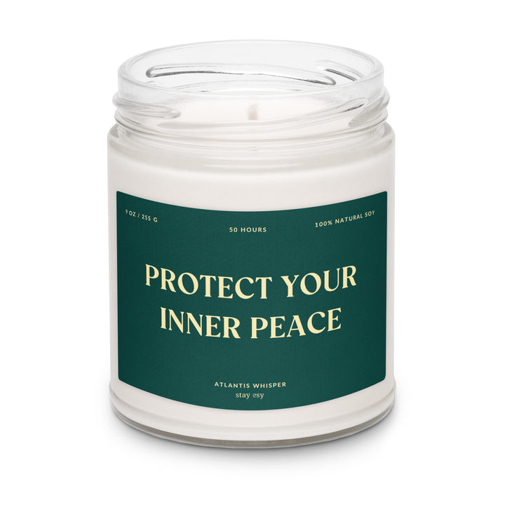 Candle in a jar with a green label reading 'Protect Your Inner Peace' on a white background