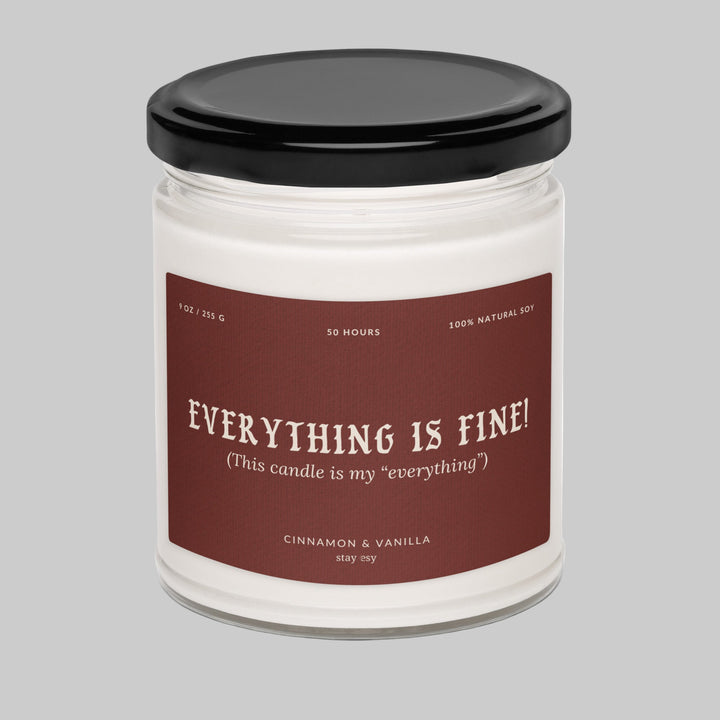 Candle jar with a label reading 'Everything is fine!' on a white background