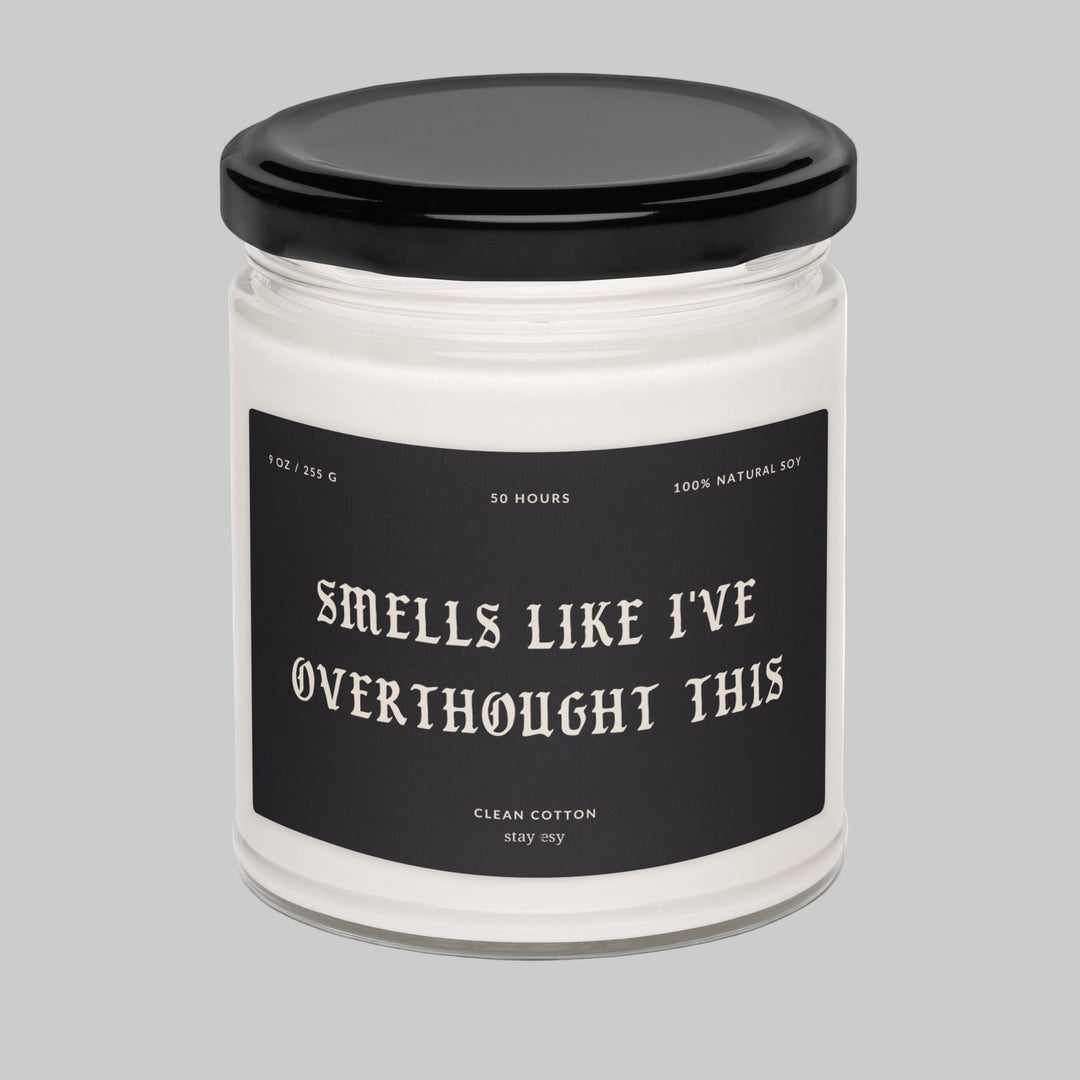 Candle jar with a black lid and humorous label on a white background