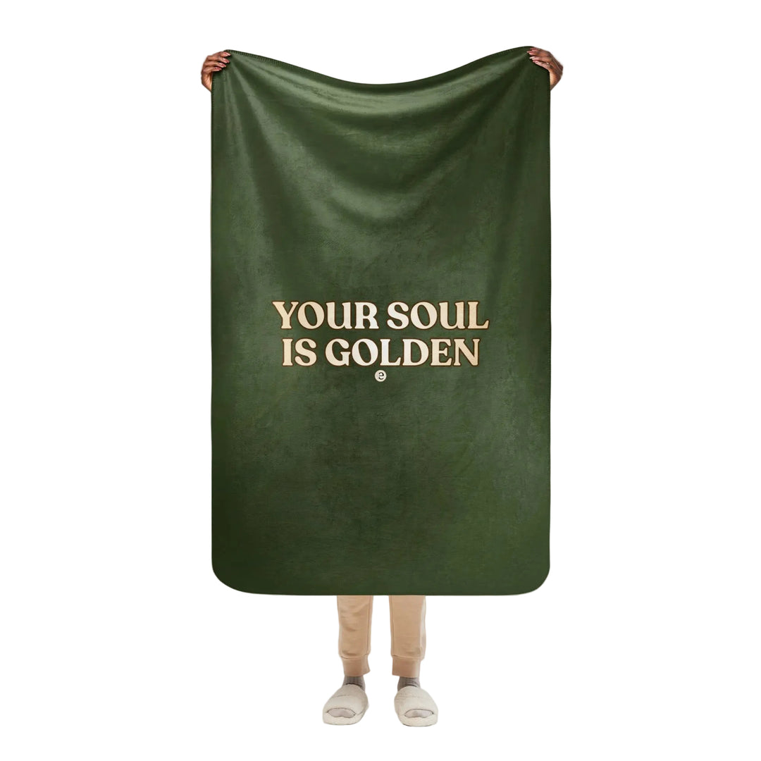 Person holding a green blanket with &