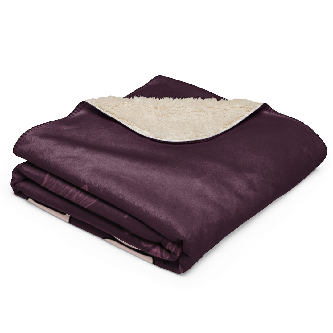 Folded blue blanket with white sherpa lining on a white background