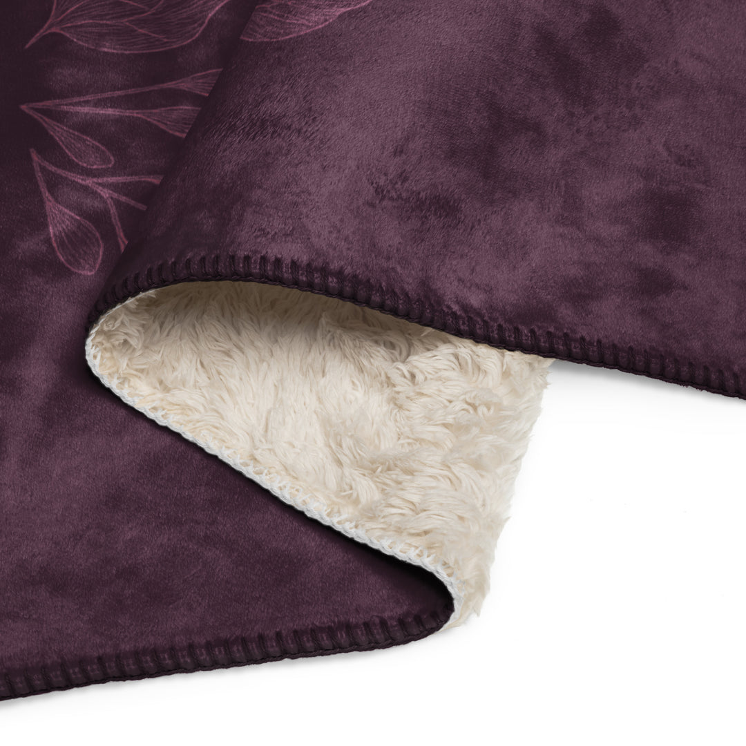 Close-up of a purple blanket with a beige fleece lining on a white background