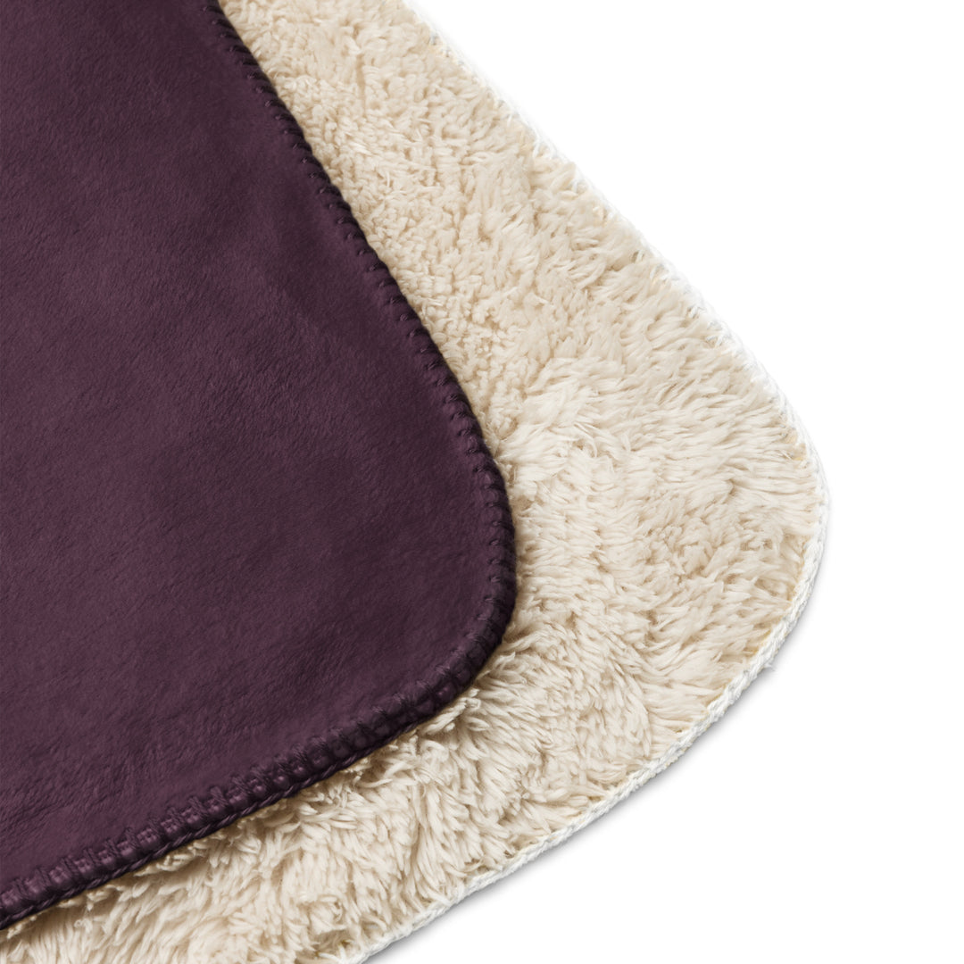 Close-up of a purple fabric with beige border on a white background
