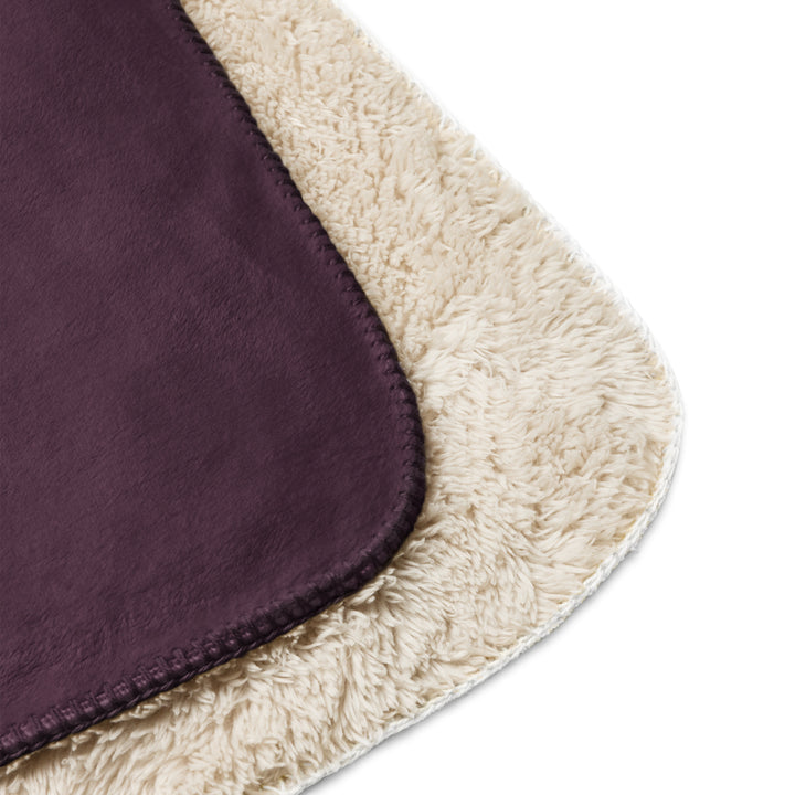 Close-up of a purple fabric with beige border on a white background