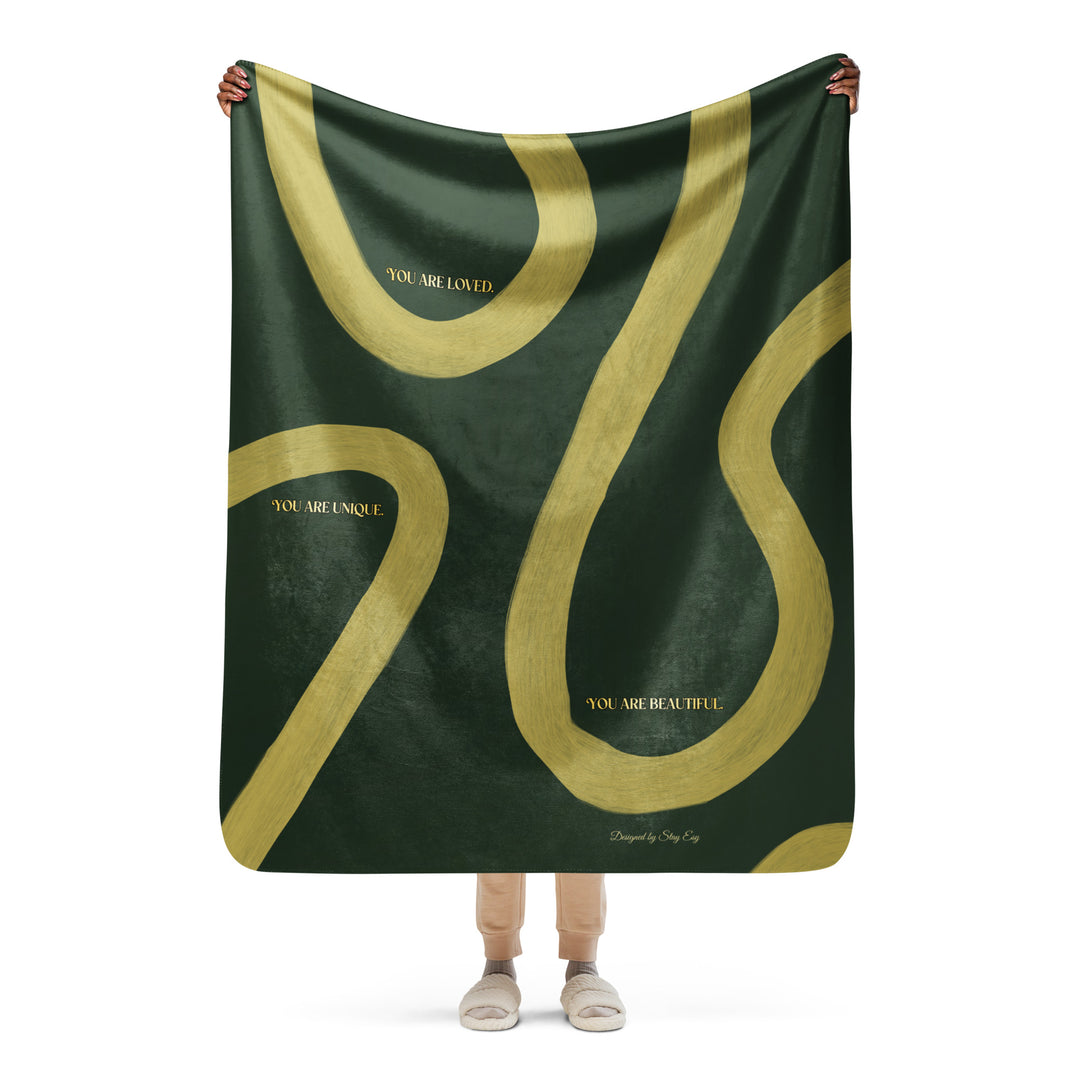 Person holding a green and gold scarf with motivational text on a white background