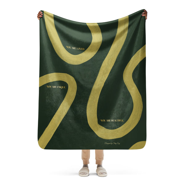 Person holding a green and gold scarf with motivational text on a white background