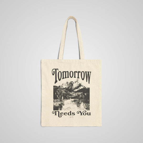 The Tomorrow Needs You Graphic Tote Bag features a bold and inspiring message on durable canvas. This large tote bag is perfect for work, school, and daily essentials.