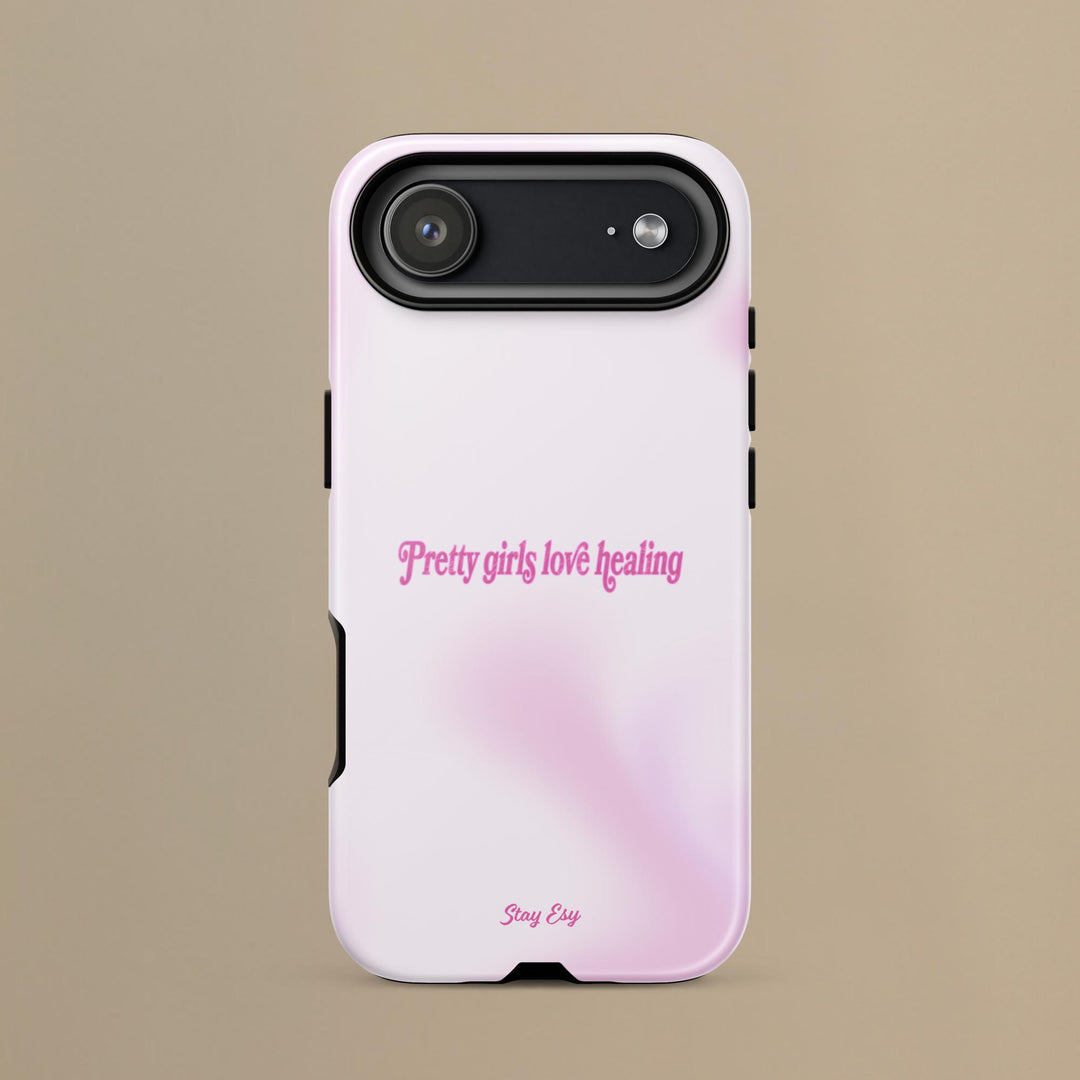 Phone case with 'Pretty girls love healing' text on a beige background