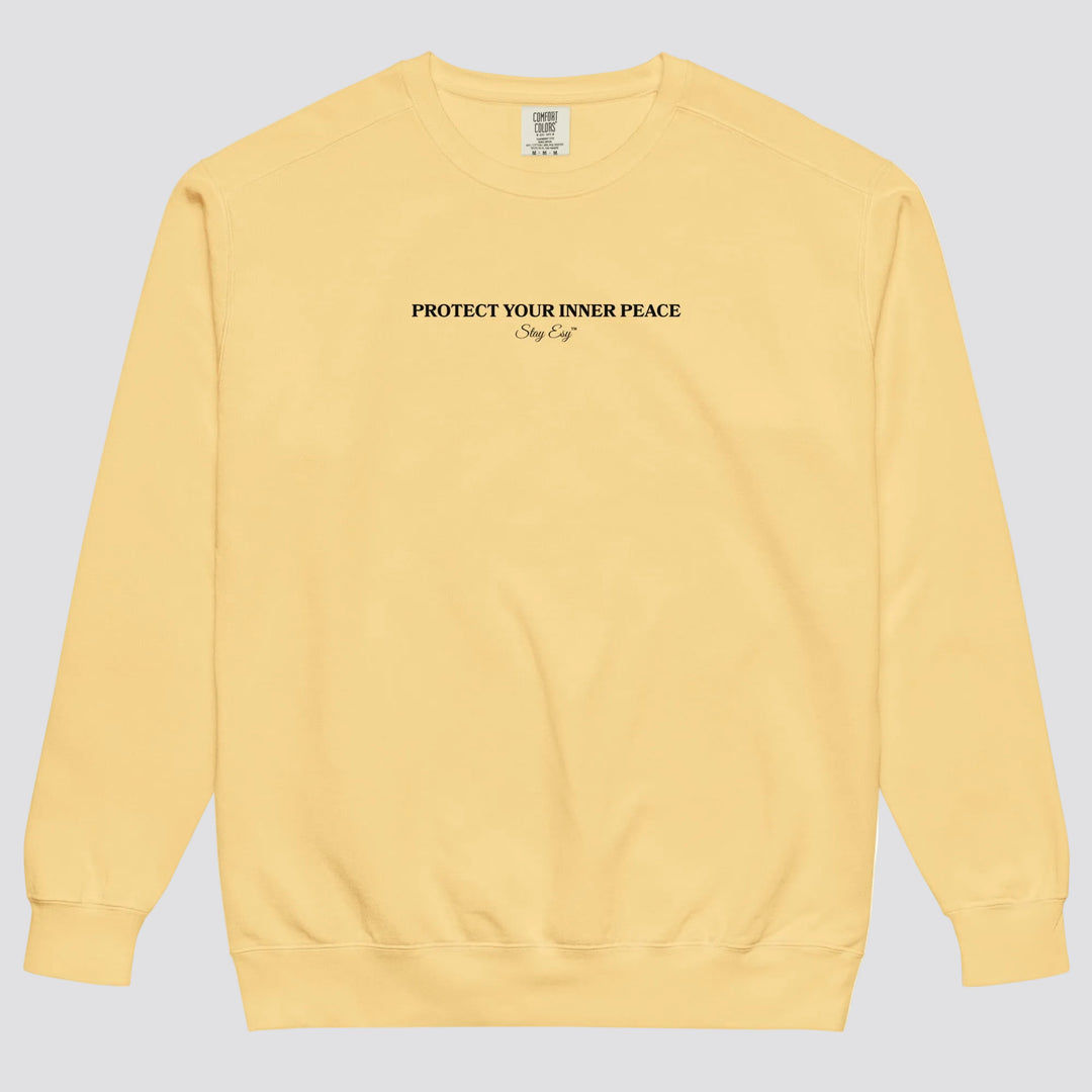 Butter unisex sweatshirt small "Protect your inner peace"graphic text in the middle of chest with "Stay Esy" trademark in script font underneath.