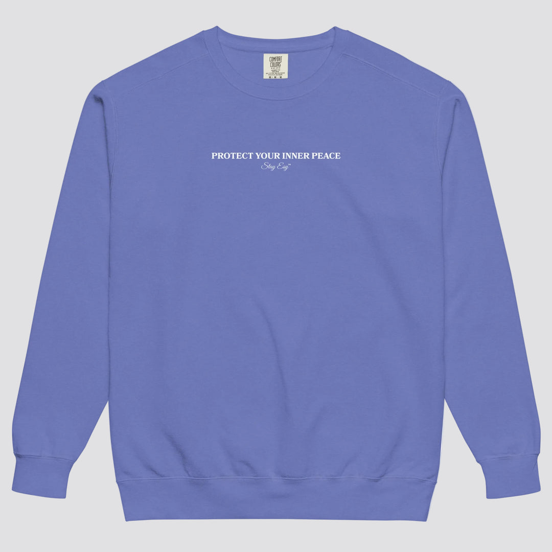 Flo Blue unisex sweatshirt small "Protect your inner peace"graphic text in the middle of chest with "Stay Esy" trademark in script font underneath.