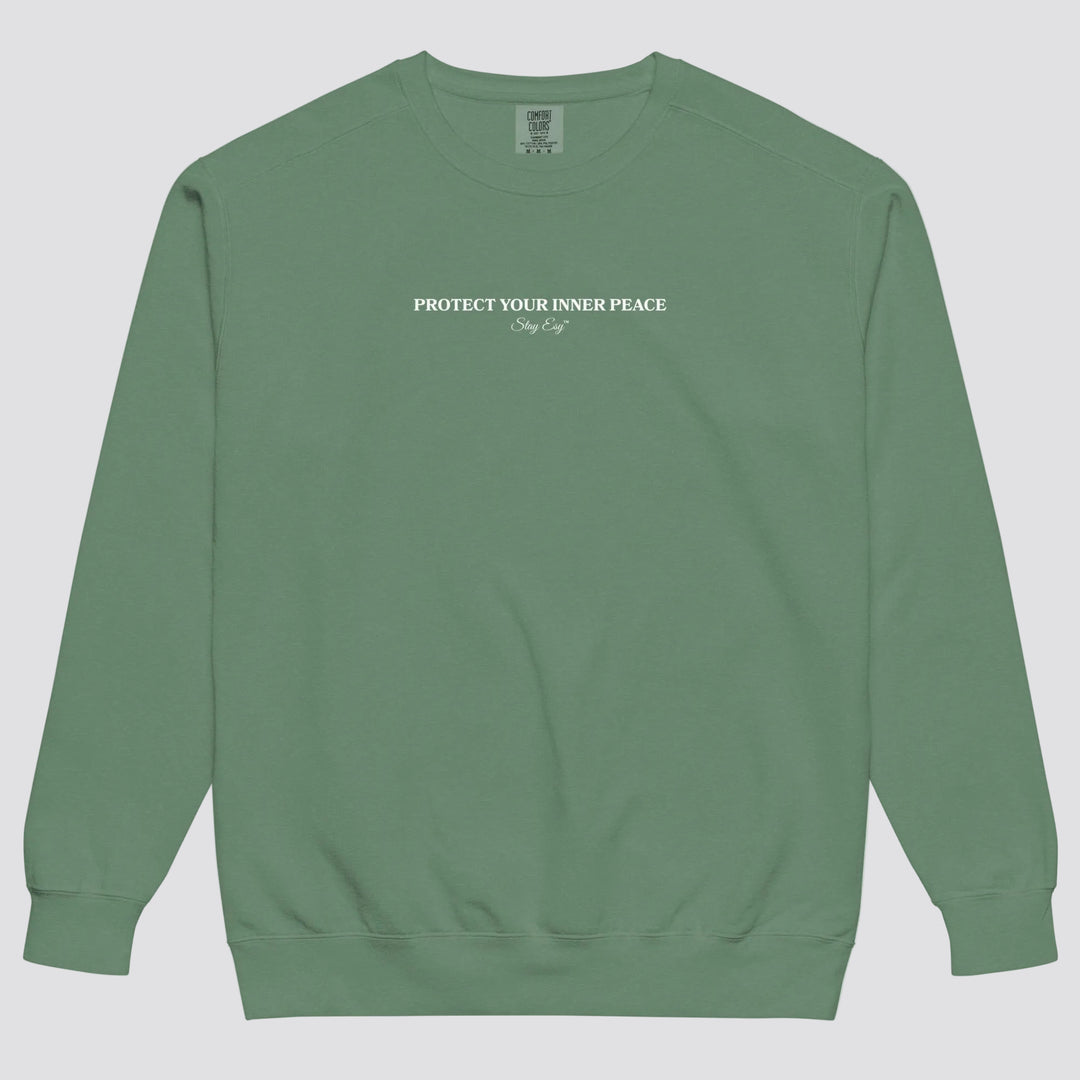Light Green unisex sweatshirt small "Protect your inner peace"graphic text in the middle of chest with "Stay Esy" trademark in script font underneath.