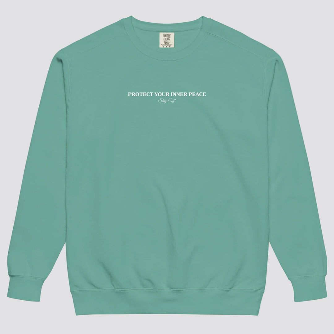 Seafoam unisex sweatshirt small "Protect your inner peace"graphic text in the middle of chest with "Stay Esy" trademark in script font underneath.