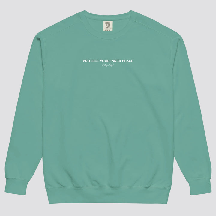 Seafoam unisex sweatshirt small "Protect your inner peace"graphic text in the middle of chest with "Stay Esy" trademark in script font underneath.