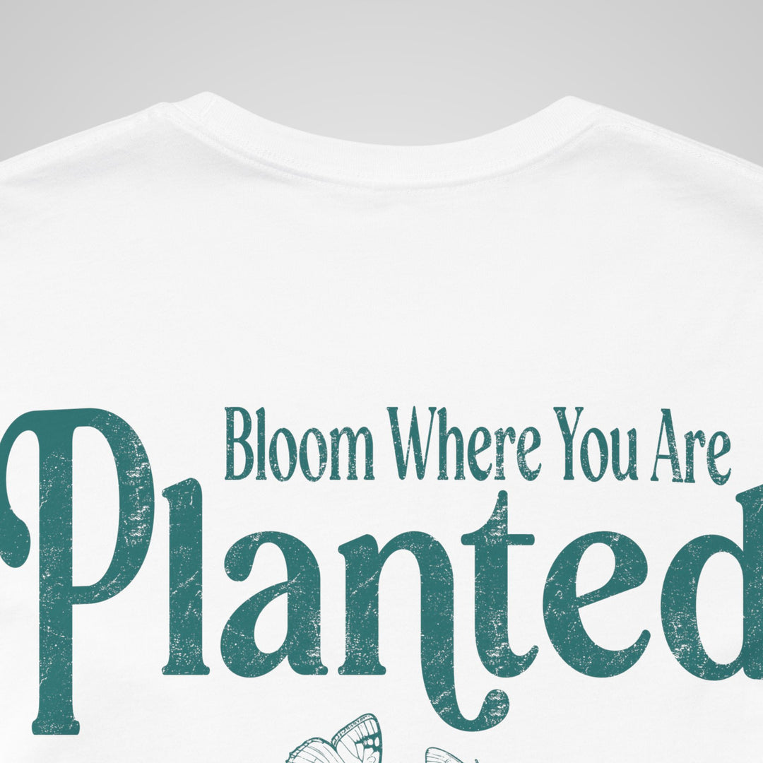 Close-up of white mental health awareness t-shirt featuring Bloom Where You Are Planted design